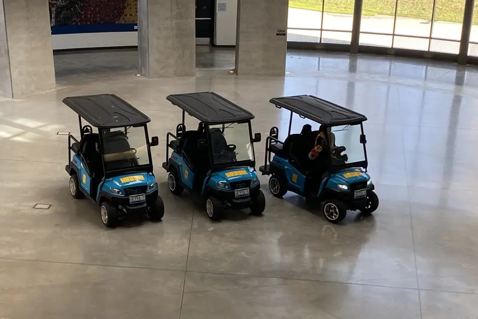 Three HeyYa carts lined up in a bright building lobby