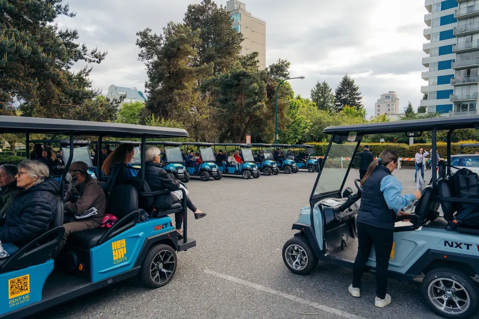An organized group of blue HeyYa carts at a community event