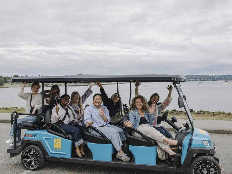 Eight-seat HeyYa cart carrying a group of friends by the waterfront