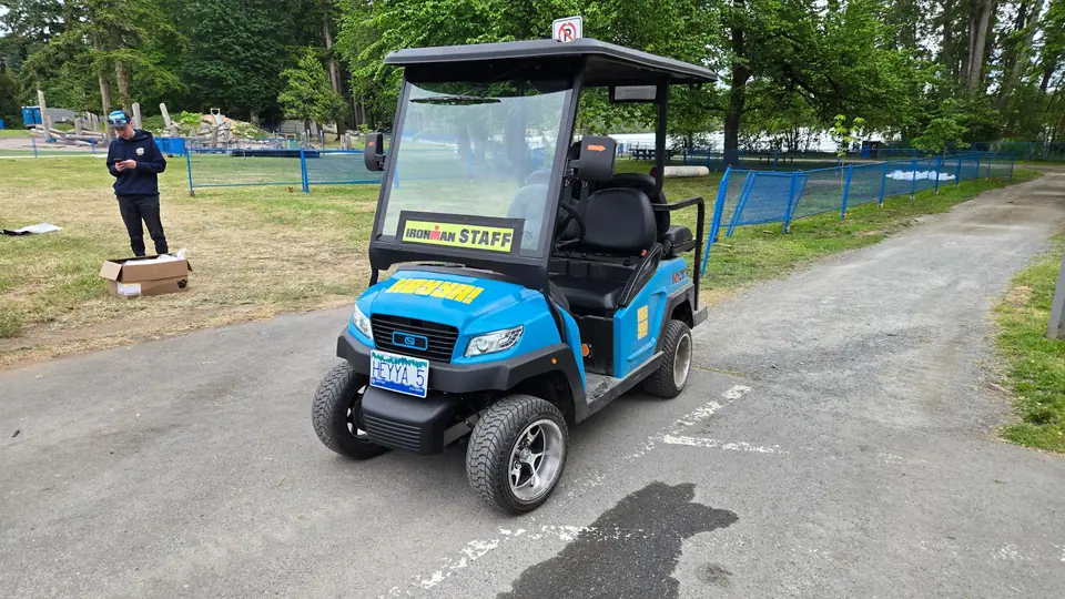 A HeyYa cart marked for race staff, staged at a triathlon venue