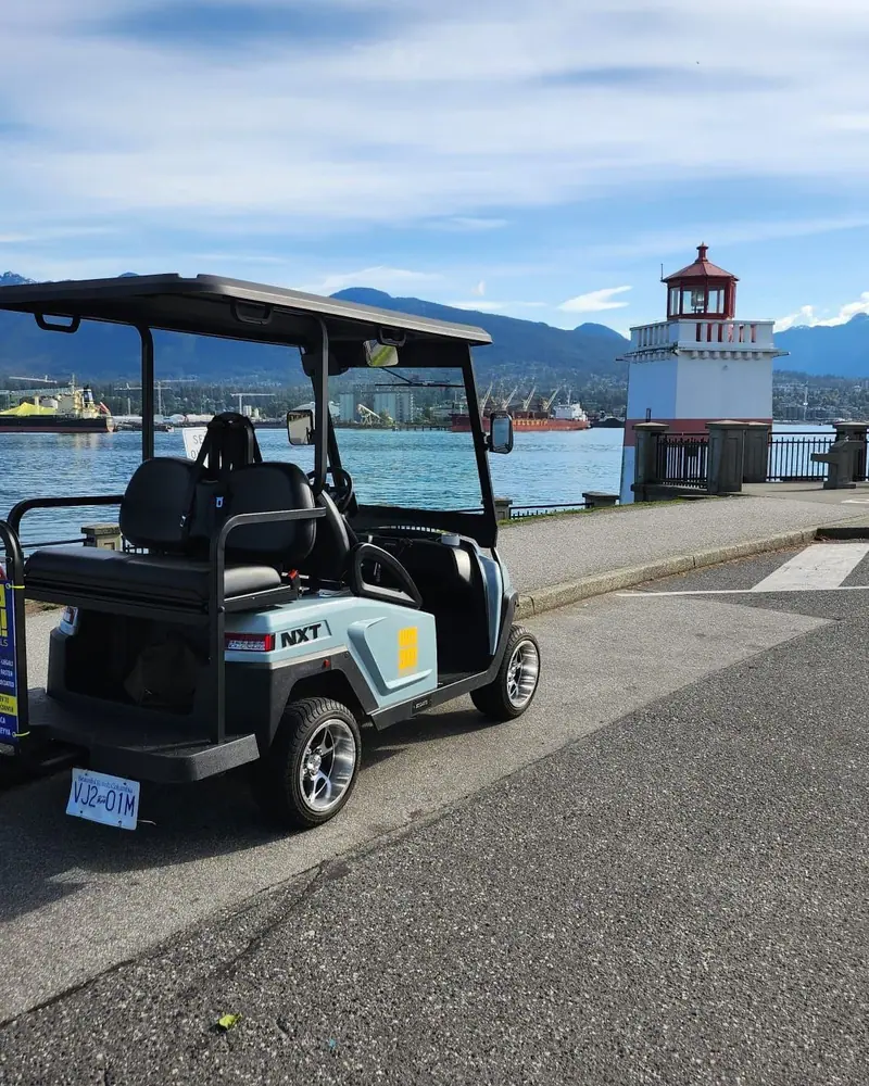 A HeyYa cart parked by the Brockton Point lighthouse in Stanley Park