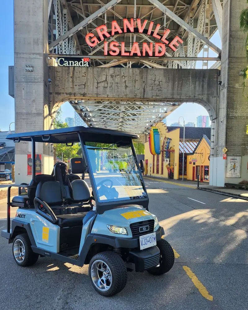 A HeyYa cart beneath the Granville Island entrance sign