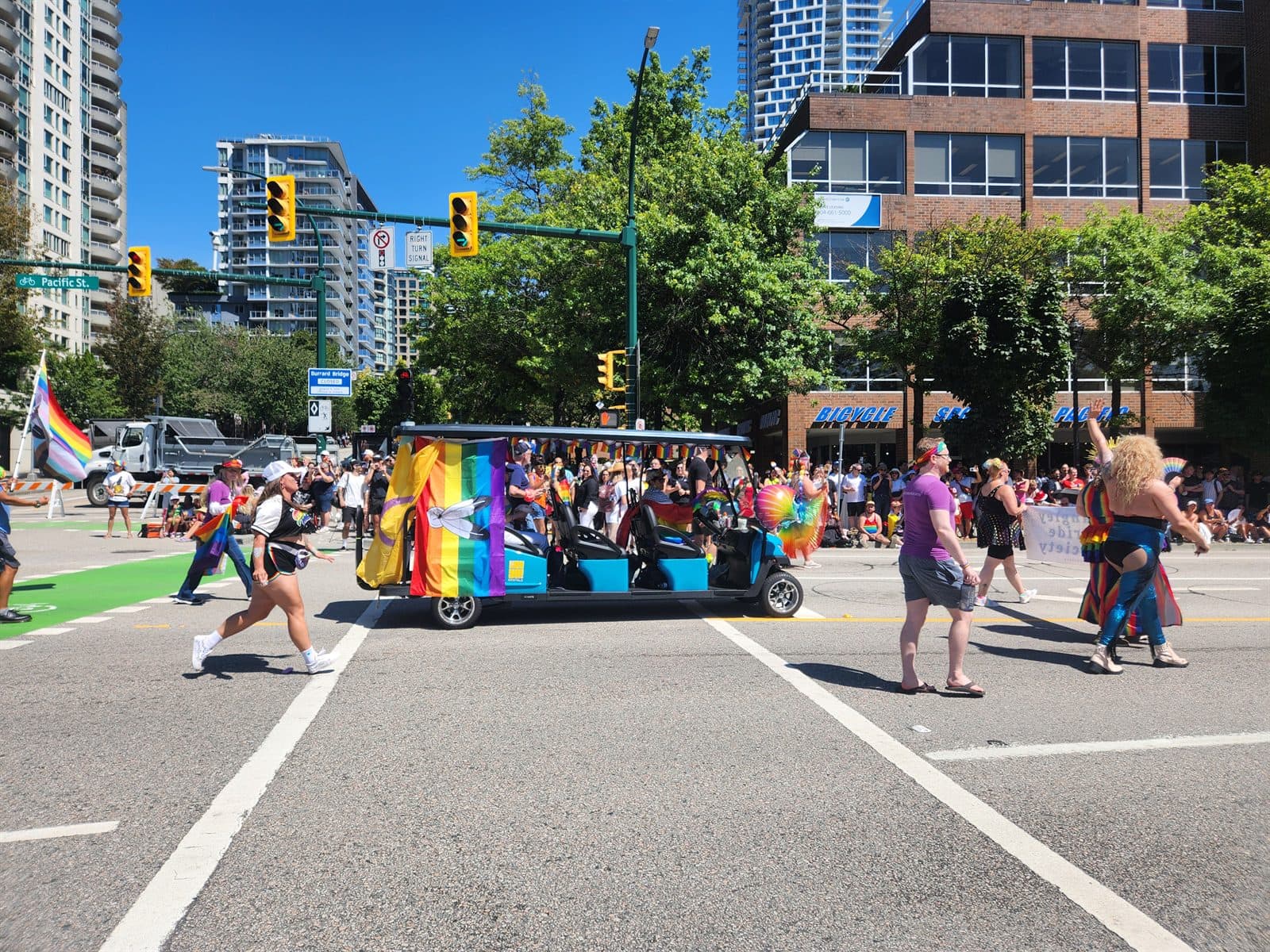 A rainbow-decorated cart moving through a Pride celebration downtown