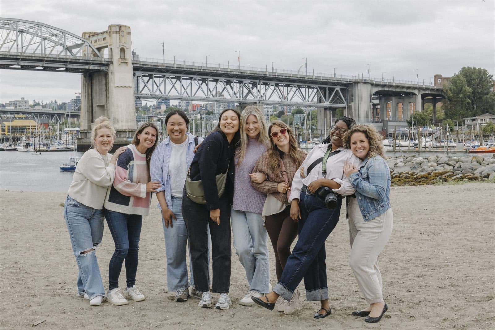 A group of friends posing together on a Vancouver beach